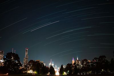 Low angle view of illuminated buildings against sky at night