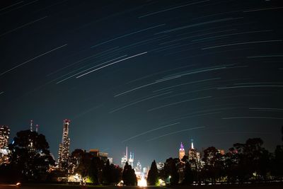 Low angle view of illuminated buildings against sky at night