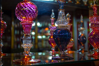 Close-up of multi colored glassware on table