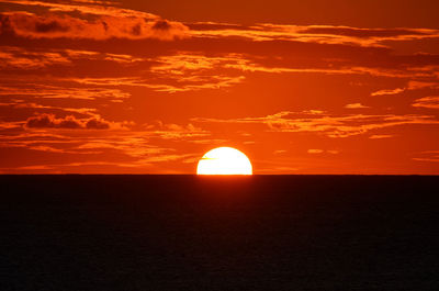 Scenic view of sea against romantic sky at sunset