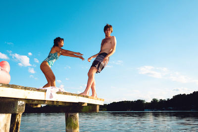 Full length of young man exercising in lake