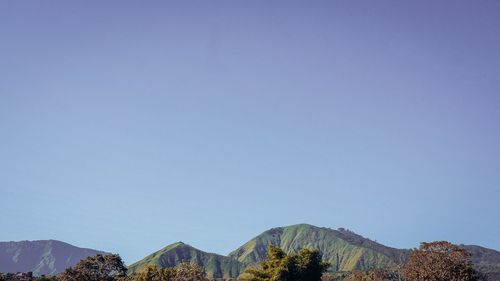 Scenic view of mountains against clear blue sky