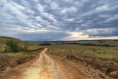 Dirt road along countryside landscape