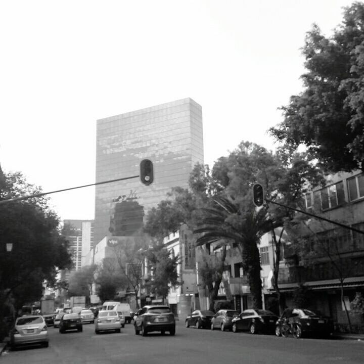 CARS ON ROAD AGAINST SKY