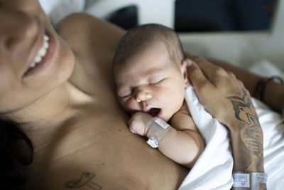 High angle view of newborn sleeping in  the hospital with mum