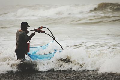 Rear view of man in sea