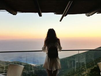 Rear view of woman looking at sea against sky