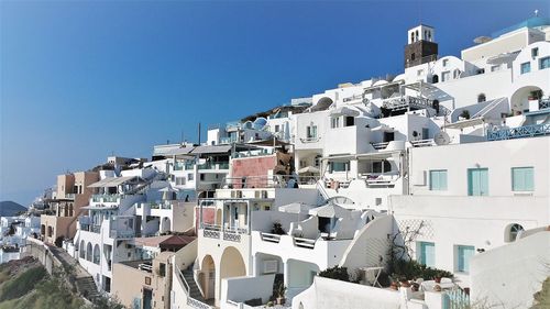 Buildings in town against blue sky
