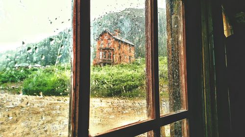 Close-up of wet window of house