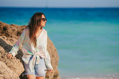 Young woman standing at beach