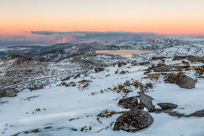 Scenic view of snow covered trees against sky during sunset