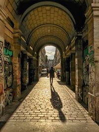 Man walking in corridor of building
