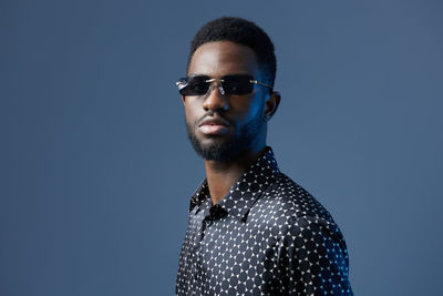 Low angle view of young man standing against clear sky