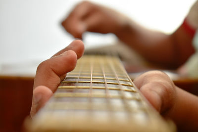 Close-up of hands playing guitar