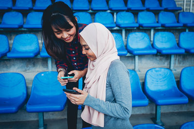 Full length of young woman using mobile phone