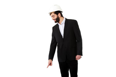 Man wearing hat standing against white background