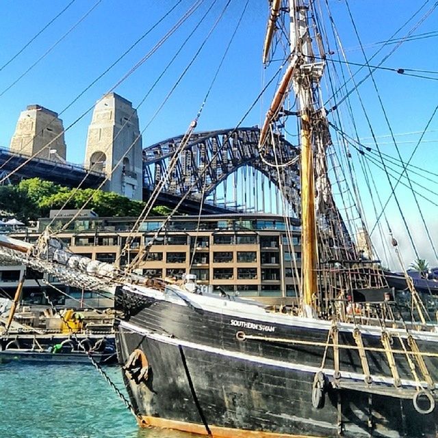 transportation, nautical vessel, mode of transport, power line, boat, built structure, cable, architecture, mast, blue, clear sky, building exterior, connection, water, electricity, electricity pylon, sky, moored, power supply, day