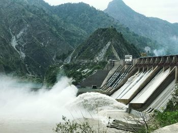Scenic view of dam against mountains
