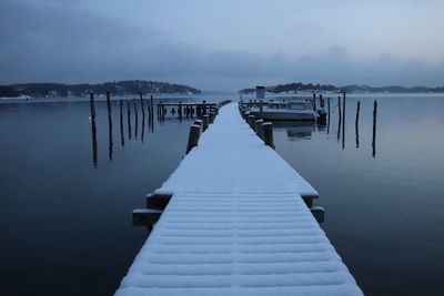 Pier over lake against sky