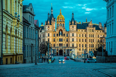 Church by buildings in city