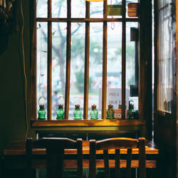 Empty chairs and table against window at home