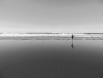 Man on beach against sky