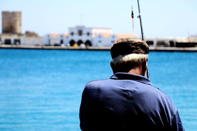 Rear view of man looking at sea