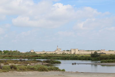 River amidst buildings against sky