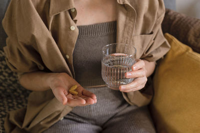 Midsection of woman holding drink