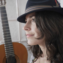 Close-up portrait of young woman wearing hat