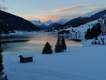 Scenic view of snowcapped mountains against sky during sunset
