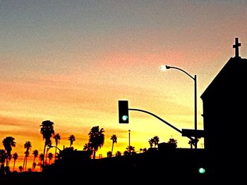 Silhouette of street light against sky at night