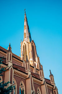 Low angle view of building against clear blue sky