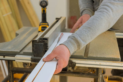 Midsection of carpenter working at workshop