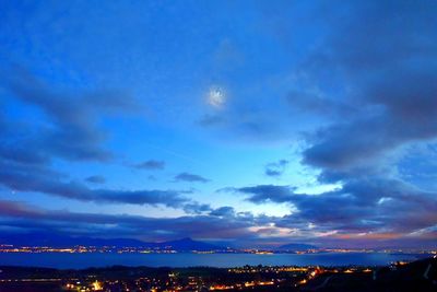View of cityscape against cloudy sky
