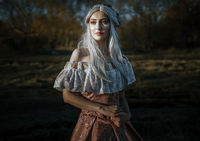 Portrait of beautiful young woman in forest