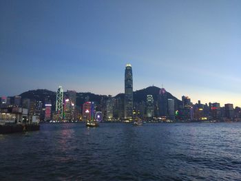 View of illuminated cityscape against clear sky