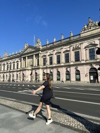 Low angle view of man walking on street