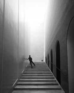 Man walking on railing