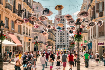 Group of people walking on street in city