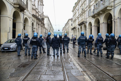 Group of people walking on street in city