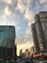 Low angle view of buildings against sky during sunset