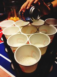 Close-up of cropped hand holding coffee cup