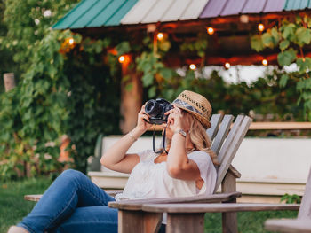 Midsection of woman sitting outdoors