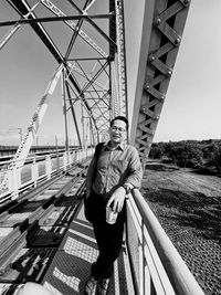 Portrait of man standing on bridge