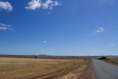 Empty road along countryside landscape