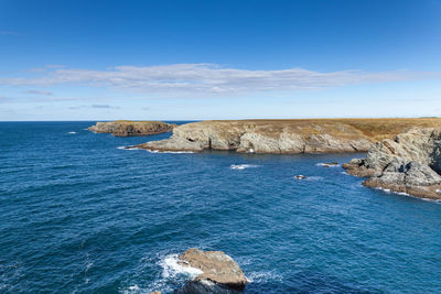 Scenic view of sea against blue sky