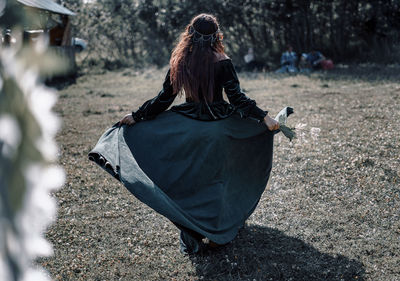 Rear view of woman on field