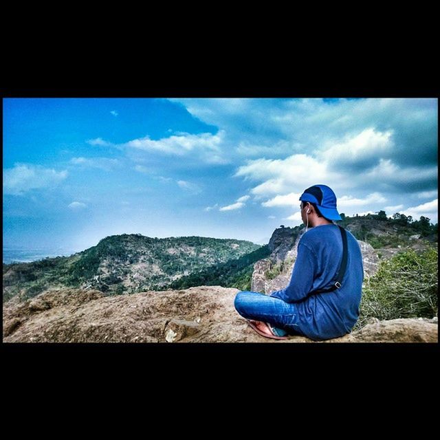 sky, mountain, lifestyles, leisure activity, landscape, transfer print, casual clothing, cloud - sky, cloud, rear view, standing, full length, sitting, auto post production filter, tranquil scene, mountain range, men, blue