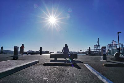 Man on woman in city against clear sky